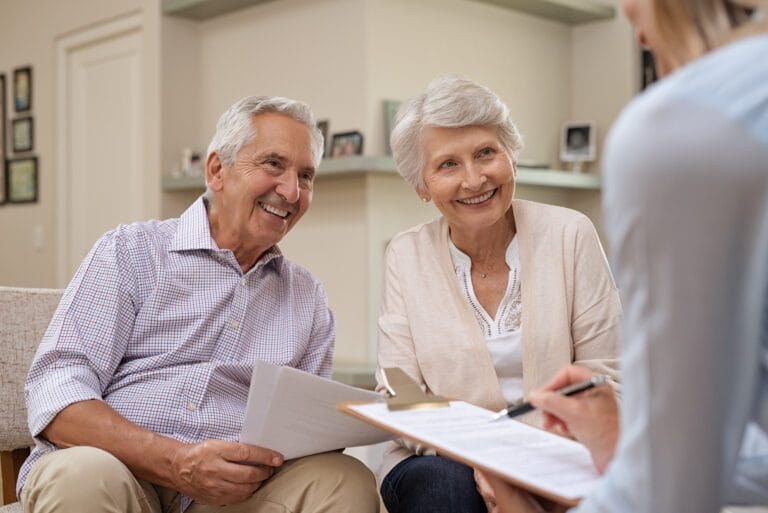 Senior couple meeting with options counselor at home.