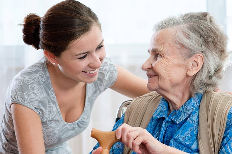 Senior woman with her home caregiver
