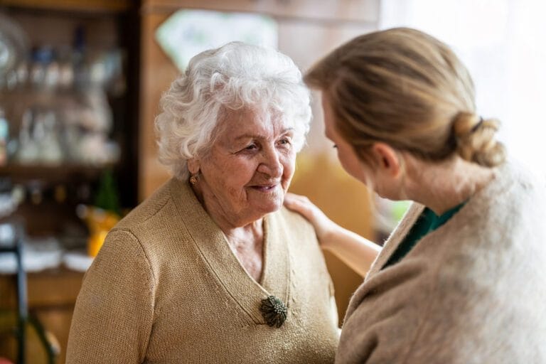 Older woman talking to her caregiver