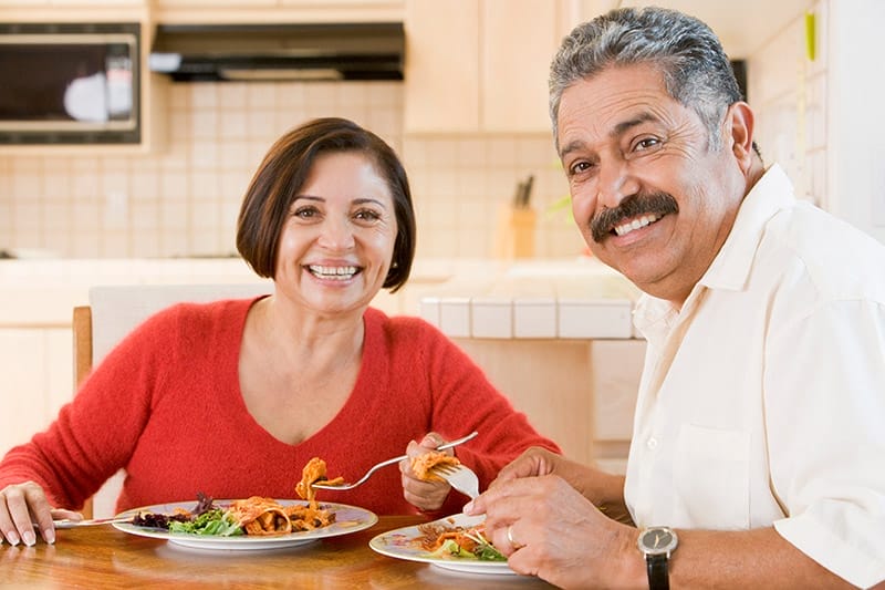 Older Latino couple enjoying mealtime together