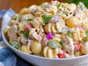 Tuna pasta salad with creamy dressing and fresh dill, celery, and red onion, served in a bowl